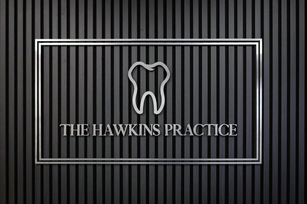 Reception lobby · chrome wordmark on black wood-slat wall · the first thing patients see